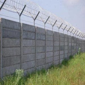 Precast wall with barbed wire fencing